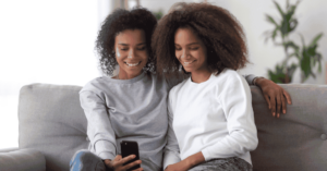 A parent and teen with a mobile phone
