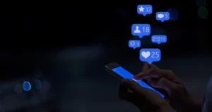 Someone uses a smartphone with browsing icons floating above it.